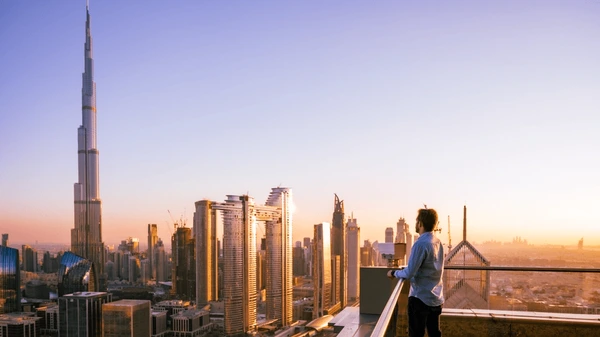 man-looking-dubai-sunset-views-600nw-2479796053